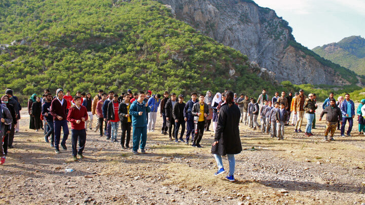 Warming up and safety briefing before an inclusive hike co-organized by students in Pakistan